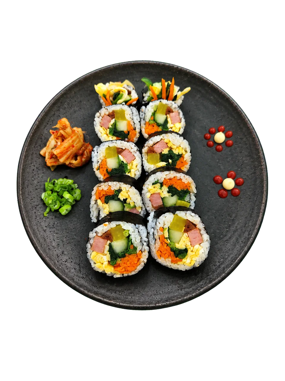 Classic ham kimbap arranged on a dark plate with kimchi and scallions.